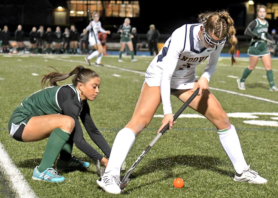 Wachusett's Lindsey McGurl, left, battles for control of a loose ball with Andover's Mia Giaimo.