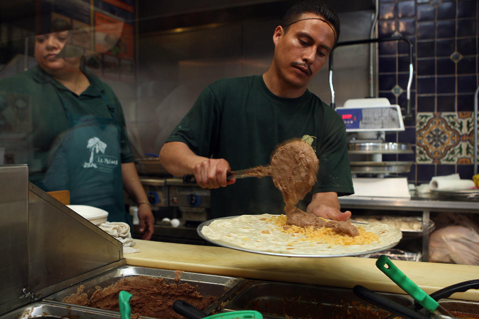 A line cook making a burrito