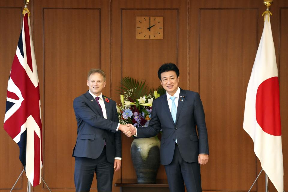 Britain's Defense Minister Grant Shapps, left, shakes hands with Japanese Defense Minister Minoru Kihara during a bilateral meeting at the defense ministry Tuesday, Nov. 7, 2023, in Tokyo. (AP Photo/Eugene Hoshiko, Pool)