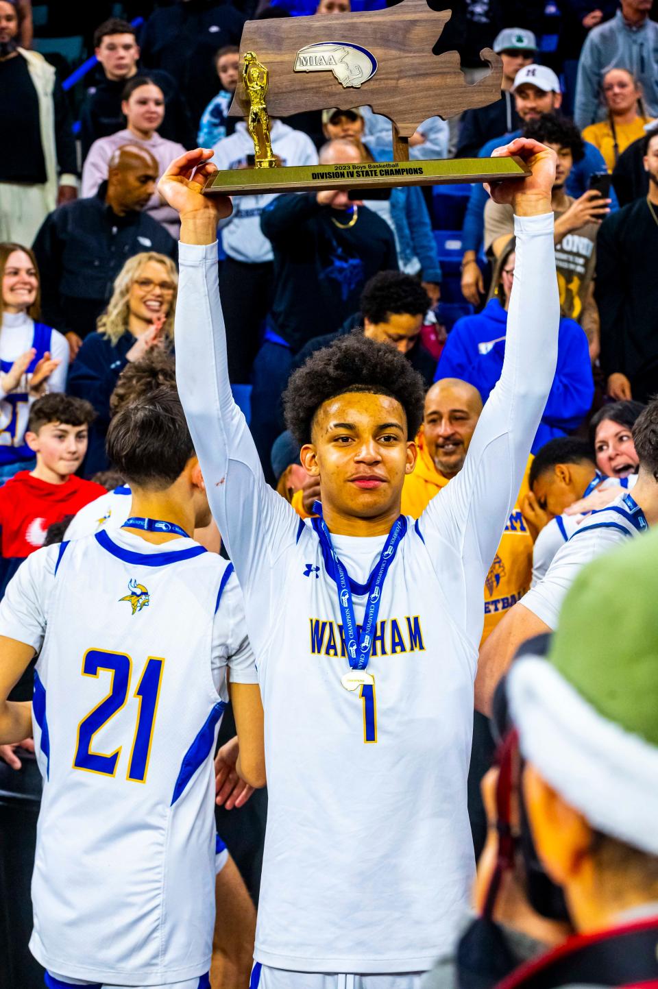 Wareham's Aaron Cote lifts the MIAA State Title Trophy.