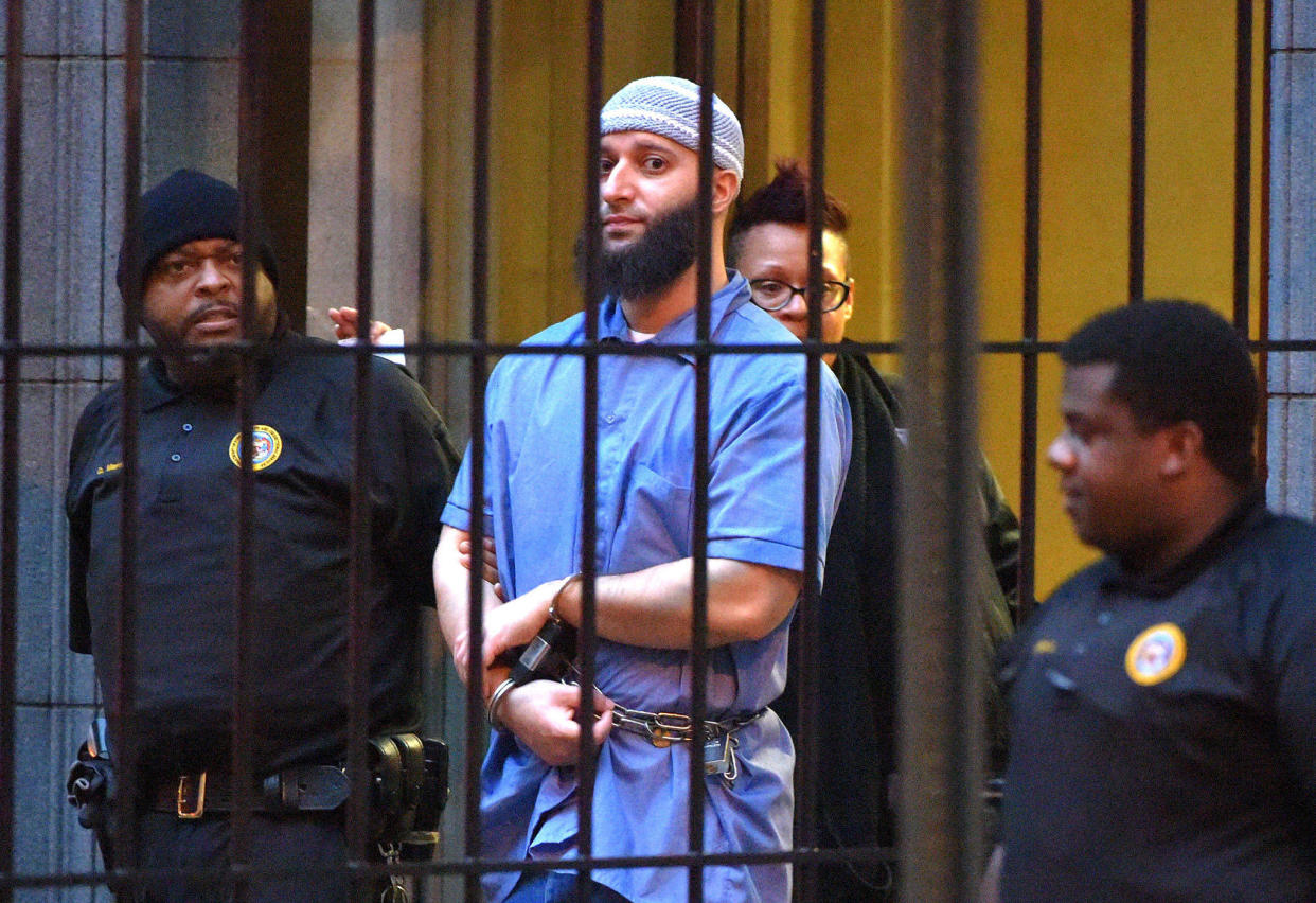 Adnan Syed is escorted from a courthouse for a retrial in Baltimore on Feb. 3, 2016. / Credit: Karl Merton Ferron/Baltimore Sun/TNS
