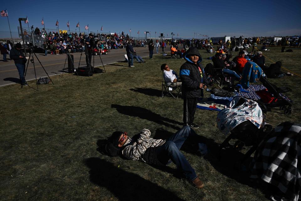 People watch the annular solar eclipse at the 51st Albuquerque International Balloon Fiesta in Albuquerque, New Mexico, on October 14, 2023.