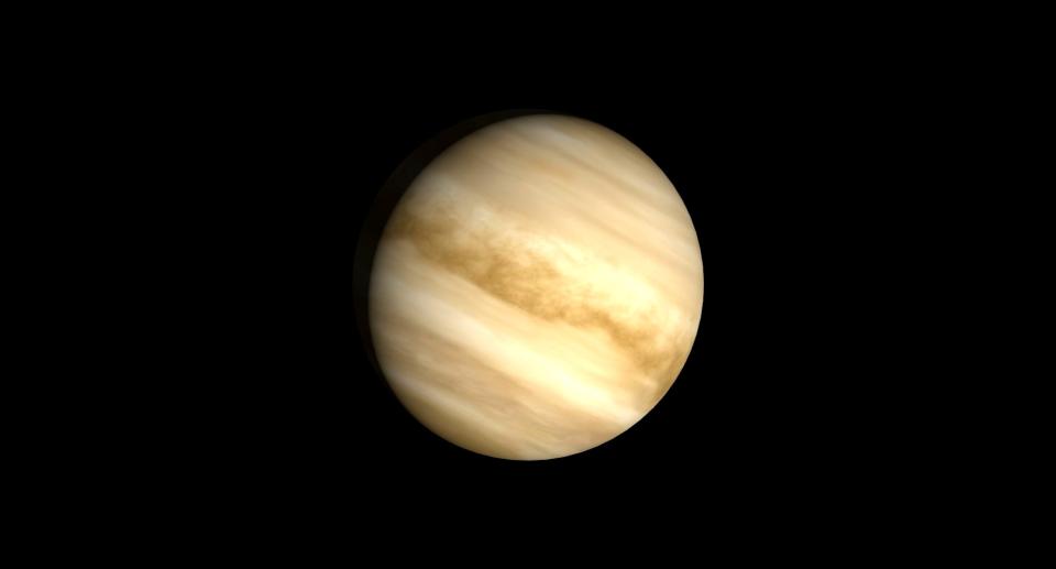     The gas of Venus folds the planet at an angle down to the right, suspended in black space. 