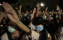 Pro-democracy students raise a three-finger salute, a resistance symbol borrowed by Thailand's anti-coup movement from the Hollywood movie "The Hunger Games," during a protest at Thammasat University in Pathum Thani, north of Bangkok, Thailand, Monday, Aug, 10, 2020. Protesters warned that they'll step up pressure on the government if it failed to meet their demands, which include dissolving the parliament, holding new elections and changing the constitution. (AP Photo/Sakchai Lalit)