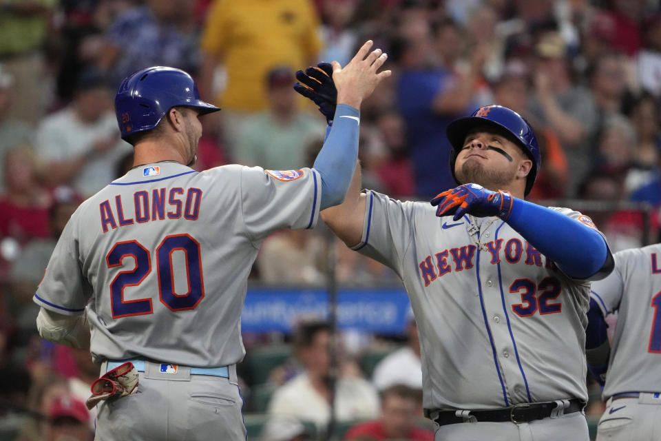 New York Mets' Daniel Vogelbach (32) is congratulated by teammate Pete Alonso (20) after hitting a grand slam during the fifth inning of a baseball game against the St. Louis Cardinals Saturday, Aug. 19, 2023, in St. Louis. (AP Photo/Jeff Roberson)