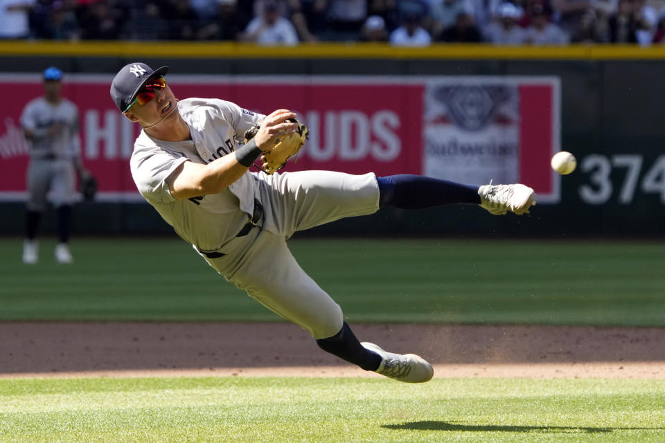 New York Yankees shortstop Anthony Volpe makes the off balance throw on a ball hit by Arizona Diamondbacks' Corbin Carroll in the tenth inning during a baseball game, Wednesday, April 3, 2024, in Phoenix. (AP Photo/Rick Scuteri)