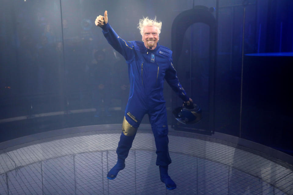 Sir Richard Branson appears in a sky diving simulator as he wears Virgin Galactic's new space-wear system, developed in partnership with Under Armour, during an event to unveil the suits to be worn by future Virgin Galactic space travelers in Yonkers, New York, U.S., October 16, 2019. REUTERS/Mike Segar