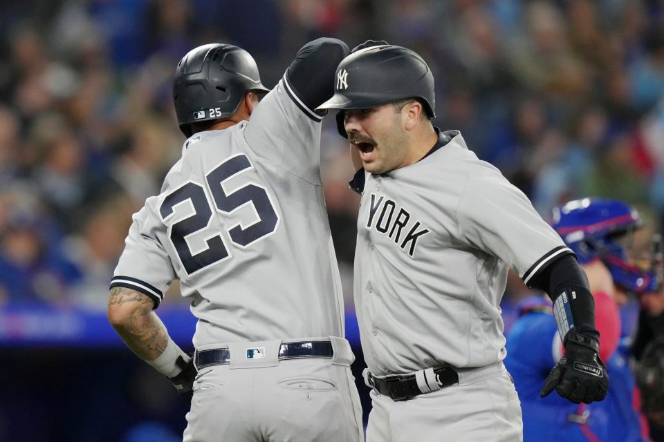 New York Yankees' Austin Wells, right, celebrates with Gleyber Torres after hitting a two-run home run off Toronto Blue Jays relief pitcher Jordan Romano during the ninth inning of a baseball game Tuesday, Sept. 26, 2023, in Toronto. (Chris Young/The Canadian Press via AP)