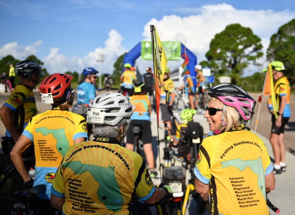 Members of the Coastal Cruisers bicycle club wait for the ribbon cutting ceremony, Friday, Sept. 9, 2022, of the new North Port Connector segment of the Legacy Trail. 