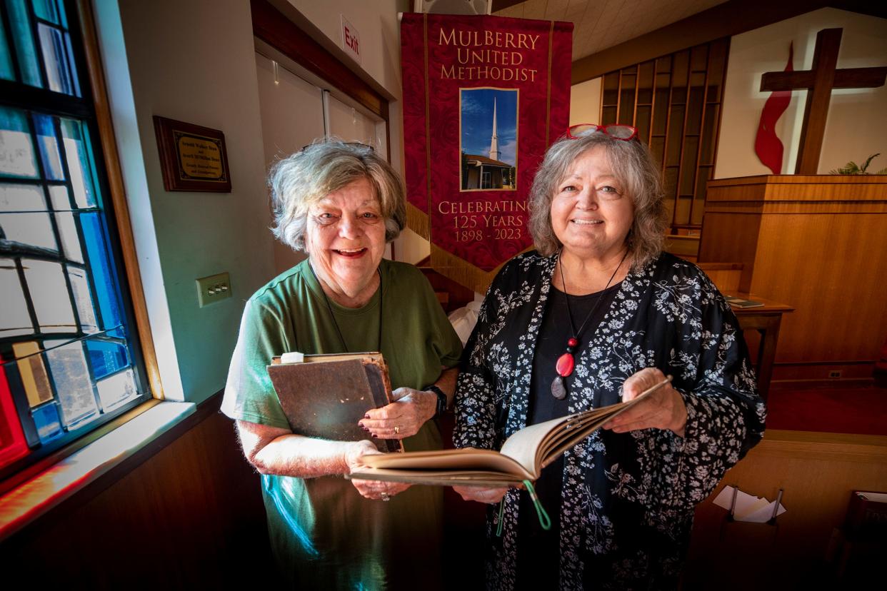 Laurie Hurst, chair of the Historical Committee, left, stands with Pastor Val Hattery in the sanctuary at Mulberry United Methodist Church. The church will celebrate its 125th anniversary on Sunday.