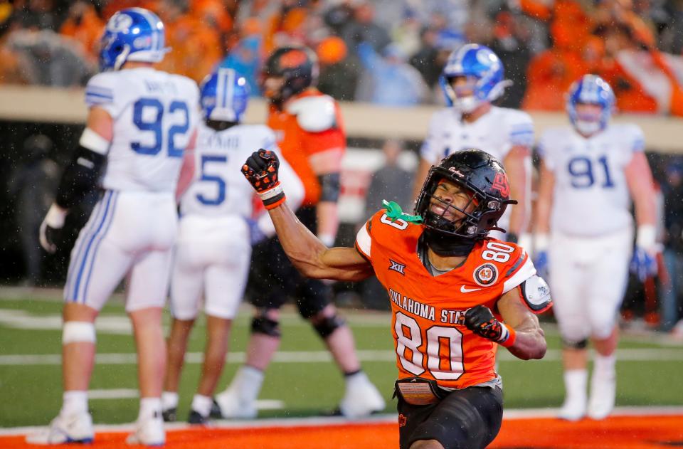 Nov 25, 2023; Stillwater, Oklahoma, USA; Oklahoma State's Brennan Presley (80) celebrates after an Oklahoma State touchdown during second half of the college football game between the Oklahoma State University Cowboys and the Brigham Young Cougars at Boone Pickens Stadium. Mandatory Credit: Sarah Phipps-USA TODAY Sports