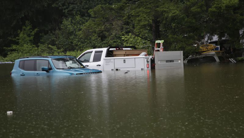 Floodwaters rise in Bridgewater, Vt., on Monday, July 10, 2023, submerging parked vehicles and threatening homes near the Ottauquechee River. Heavy rain drenched part of the Northeast, washing out roads, forcing evacuations and halting some airline travel. 