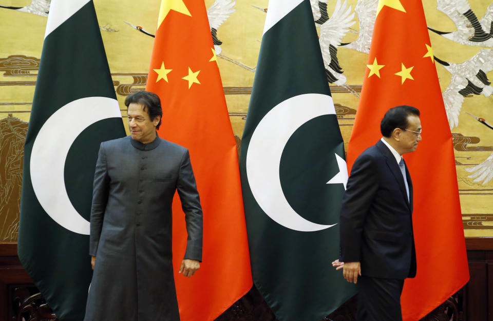 Pakistani Prime Minister Imran Khan, left, and China's Premier Li Keqiang leave after a signing ceremony at the Great Hall of the People in Beijing Saturday, Nov. 3, 2018. (Jason Lee/Pool Photo via AP)