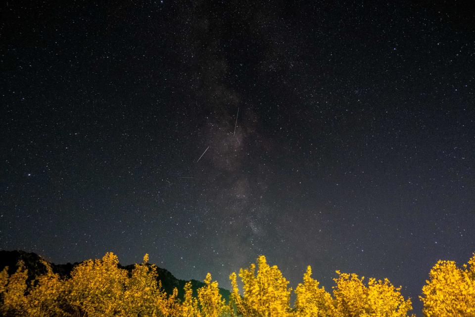 TOPSHOT - Meteors of the Orionid meteor shower streak as they cross through the milkyway in the mountainous area of Tannourine in northern Lebanon, on October 3, 2021. (Photo by Ibrahim CHALHOUB / AFP) (Photo by IBRAHIM CHALHOUB/AFP via Getty Images)