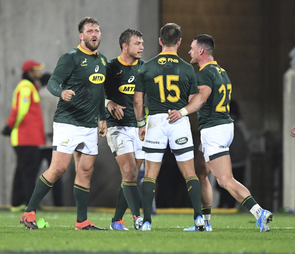 South Africa celebrate their 16 all draw with New Zealand during a Rugby Championship match between the All Blacks and South Africa in Wellington, New Zealand, Saturday, July 27, 2019. (AP Photo/Ross Setford)