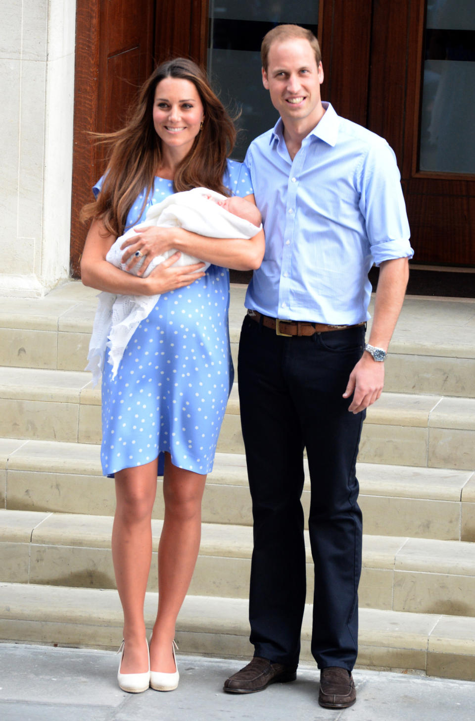 <p>Kate welcomed Prince George in a bespoke blue-and-white polka dot dress by Jenny Packham. On her feet, the Duchess chose cream wedges from Pied a Terre. </p><p><i>[Photo: PA]</i></p>