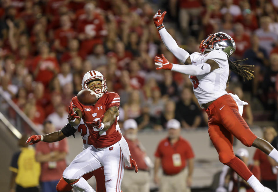 Wisconsin wide receiver A.J. Taylor misses a reception against Western Kentucky defensive backs DeAndre Farris, rear, and Drell Greene during the first half of an NCAA college football game Friday, Aug. 31, 2018, in Madison, Wis. (AP Photo/Andy Manis)