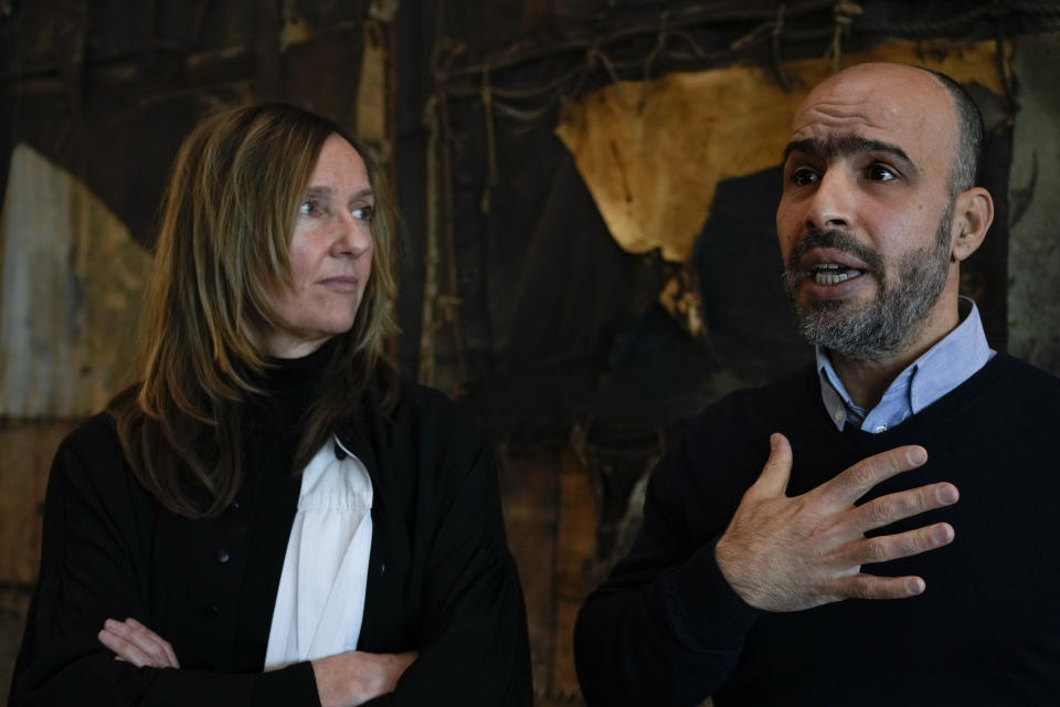 Dutch-Palestinian Ismail Ziada and his lawyer Liesbeth Zegveld, left, are interviewed after a Dutch appeals court in The Hague Tuesday, Dec. 7, 2021, upheld a lower court's decision to throw out a civil case against Israel's defense minister and another former senior military officer over their roles in a deadly 2014 airstrike in Gaza which killed six members of the Ziada family. (AP Photo/Peter Dejong)