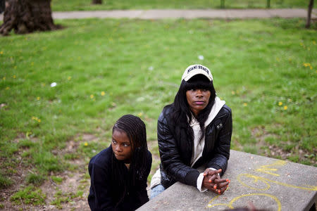 Lakesha Johnson (R), a homeless health care aide, and her 11-year-old daughter, Aja, sit on a park bench in Philadelphia, Pennsylvania, U.S. April 26, 2017. REUTERS/Mark Makela