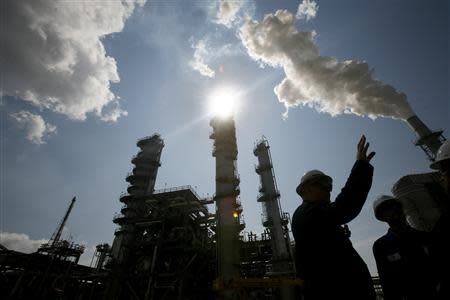 James Prokupek (L), an engineering department process design manager for the Valero St. Charles Oil Refiner, is seen in silhouette during a tour of the refinery in Norco, Louisiana, in thi August 15, 2008 file photo. REUTERS/Shannon Stapleton/Files