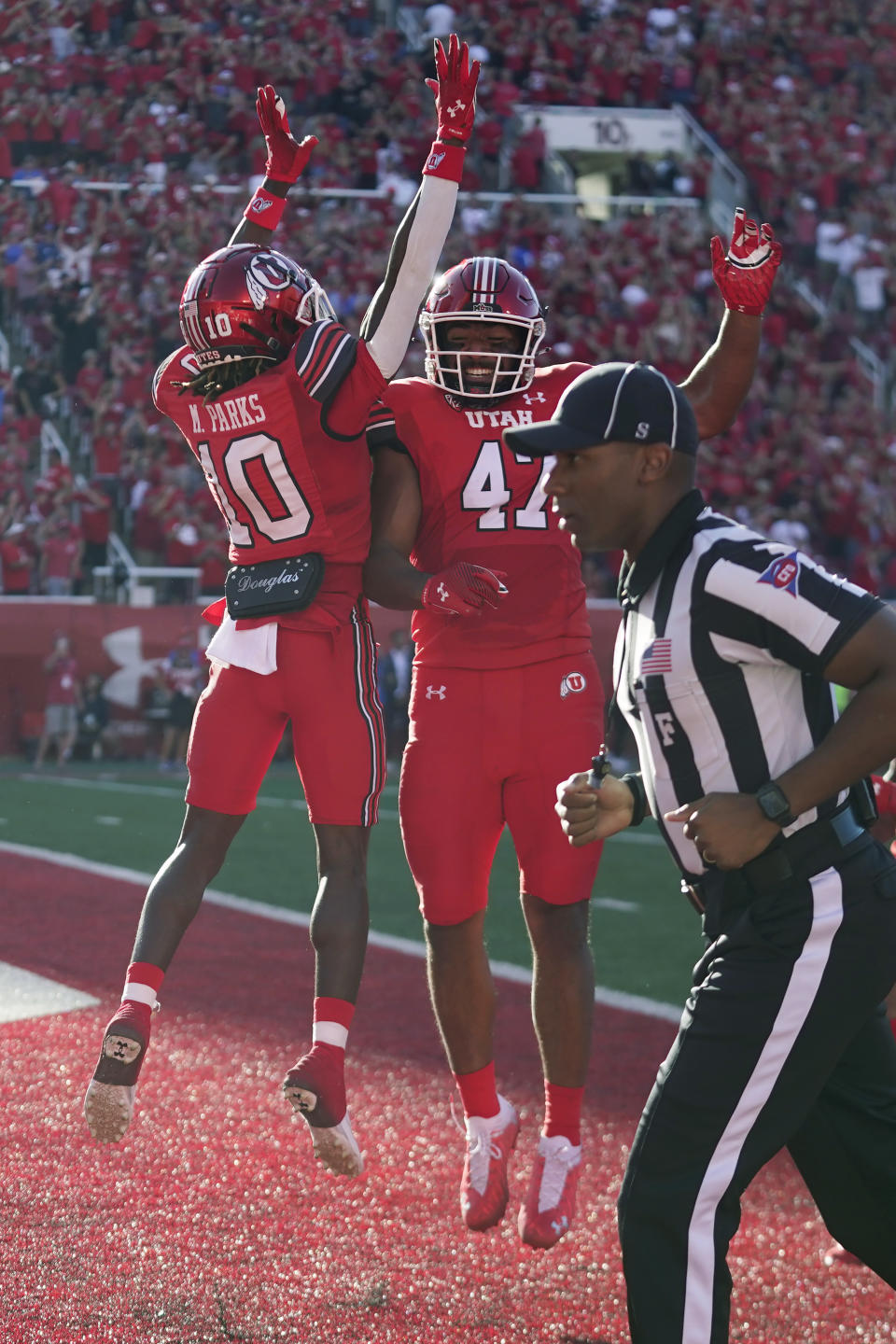 Utah wide receiver Money Parks (10) celebrates with Miki Suguturaga (47) after scoring against Florida during the first half of an NCAA college football game Thursday, Aug. 31, 2023, in Salt Lake City. (AP Photo/Rick Bowmer)