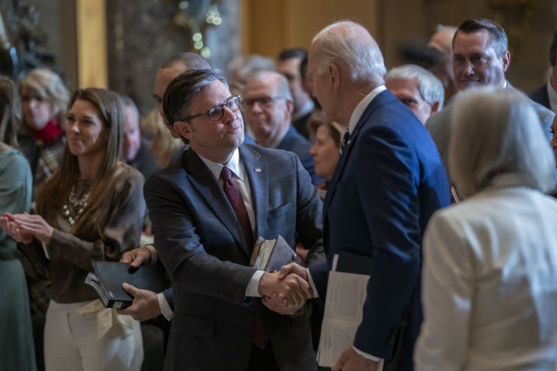 President Joe Biden shakes hands with Speaker of the House Mike Johnson during the National Prayer Breakfast in Statuary Hall of the U.S; Capitol on Thursday. Photo by Shawn Thew/UPI