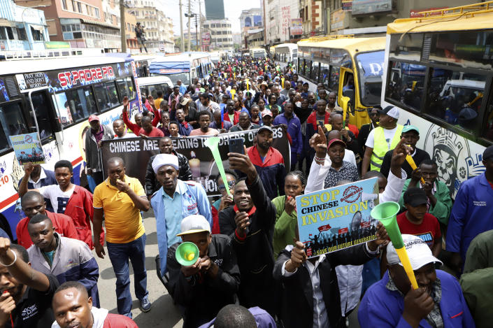 Small and medium business traders and other demonstrators carry banners as they protest asking the government to chase Chinese traders away, in Nairobi, Kenya, Tuesday, Feb. 28, 2023. The traders carried banners with Anti-Chinese messages and chanted 'Chinese must go', claiming Chinese businesspeople have flooded the city with counterfeit and cheap products, killing Kenyan businesses. (AP Photo)