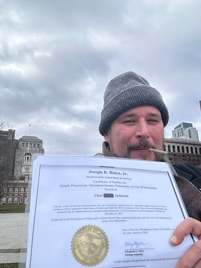 NORML regional organizer Chris Goldstein poses with his presidential pardon for marijuana possession in Philadelphia.