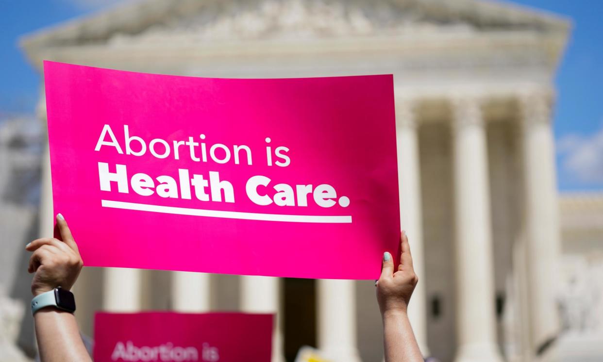 <span>Abortion rights demonstrators hold signs outside the supreme court in Washington DC on 24 June 2023.</span><span>Photograph: Stephanie Scarbrough/AP</span>