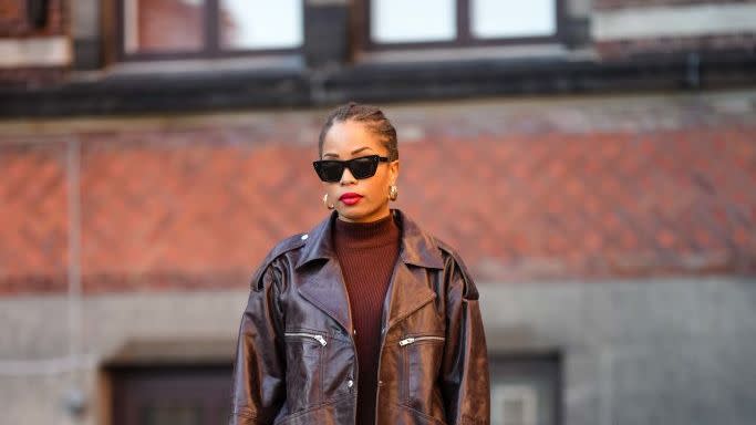 street style day 4 copenhagen fashion week autumnwinter 2023 with a sweater dress leather jacket and leather boots