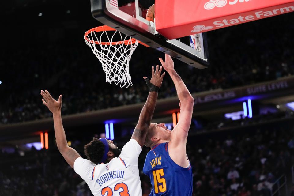 Denver Nuggets center Nikola Jokic (15) goes to the basket against New York Knicks center Mitchell Robinson (23) during the first half of an NBA basketball game, Saturday, March 18, 2023, at Madison Square Garden in New York. (AP Photo/Mary Altaffer)
