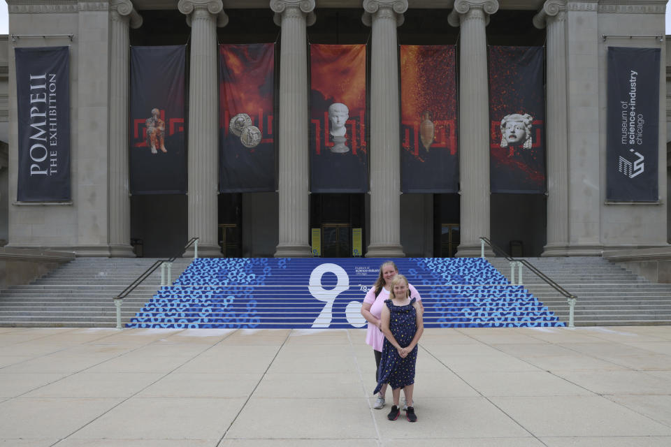 Flower Nichols, an 11-year-old transgender girl, poses in front of the Museum of Science and Industry with her mother, Jennilyn, during a visit to Chicago on June 13, 2023. Families around the U.S. are scrambling to navigate new laws that prohibit their transgender children from accessing gender-affirming care. At least 20 states are moving to ban or restrict such care for minors. (AP Photo/Teresa Crawford)