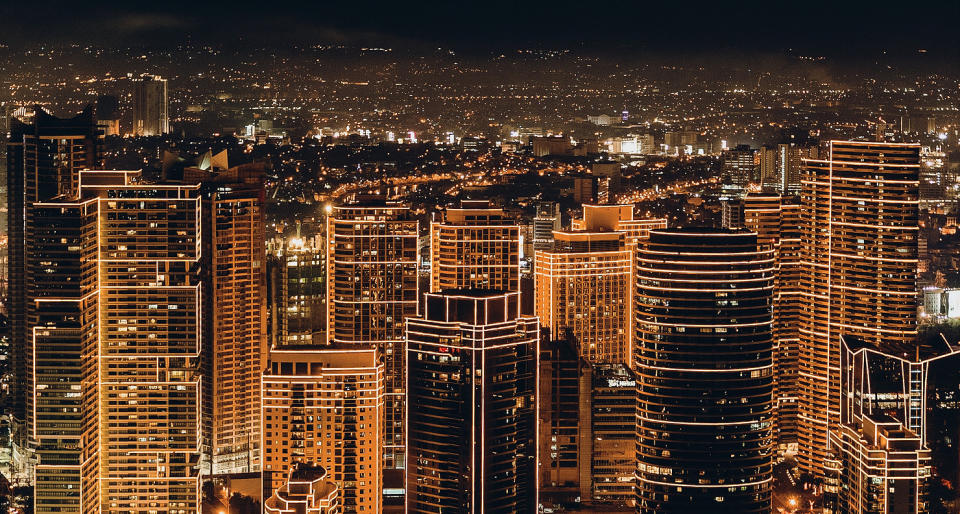 A cityscape at night, with outlines superimposed over tall buildings