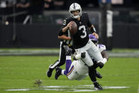 Las Vegas Raiders quarterback Jarrett Stidham is tackled by Minnesota Vikings defensive tackle T.Y. McGill during the first half of an NFL preseason football game, Sunday, Aug. 14, 2022, in Las Vegas. (AP Photo/John Locher)