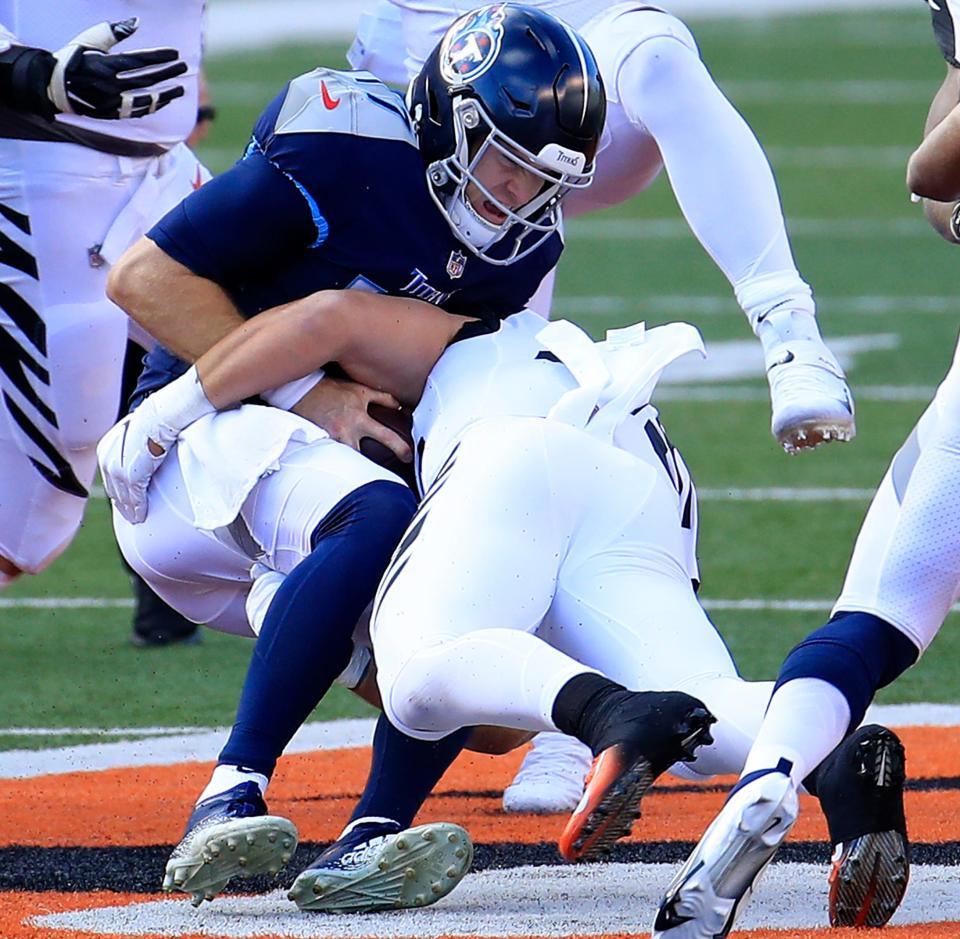 Linebacker Logan Wilson (55) of the Cincinnati Bengals tackles Quarterback Ryan Tannehill (17) of the Tennessee Titans for a sack in the third quarter of the game at Paul Brown Stadium on November 01, 2020 in Cincinnati, Ohio.