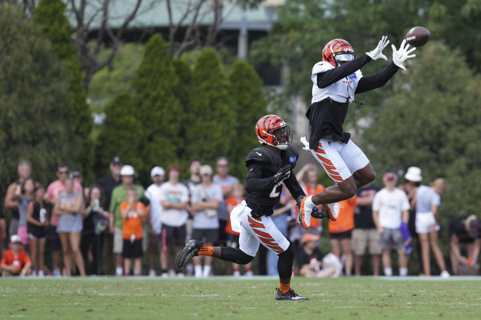 Cincinnati Bengals wide receiver Ja'Marr Chase, right, makes a catch past cornerback Eli Apple during NFL football training camp Wednesday, Aug. 10, 2022, in Cincinnati. (AP Photo/Jeff Dean)