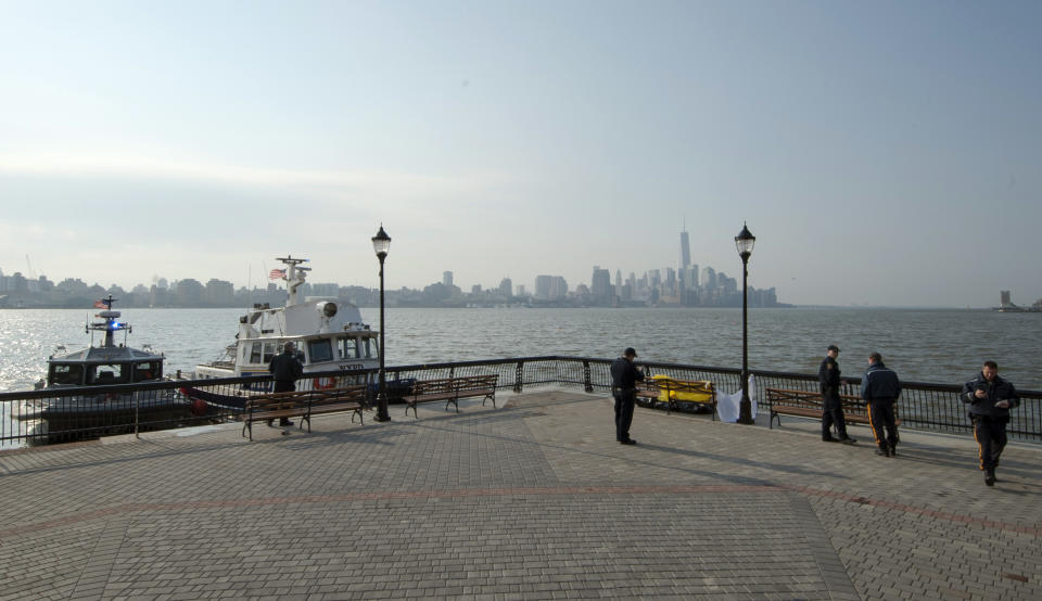 Police investigate the scene after divers found the bodies of two people in the Hudson River near Sinatra Park, Sunday, April 13, 2014 in Hoboken, N.J. Police have not identified the victims. (AP Photo/Joe Epstein)