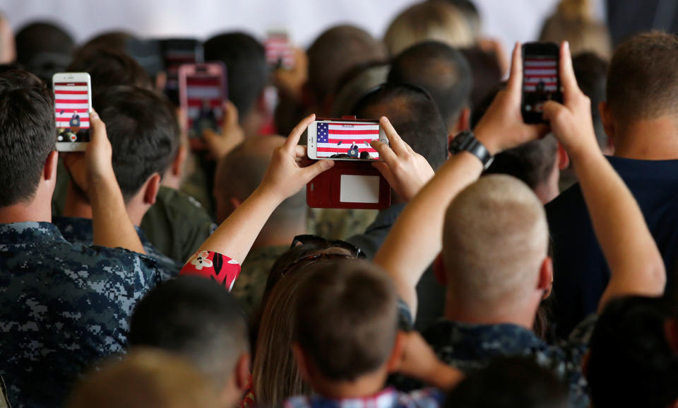 <p>U.S. military personnel take pictures of U.S. President Donald Trump as he delivers remarks at the Naval Air Station Sigonella following the G7 Summit, in Sigonella, Sicily, Italy, May 27, 2017. (Photo: Darrin Zammit Lupi/Reuters) </p>