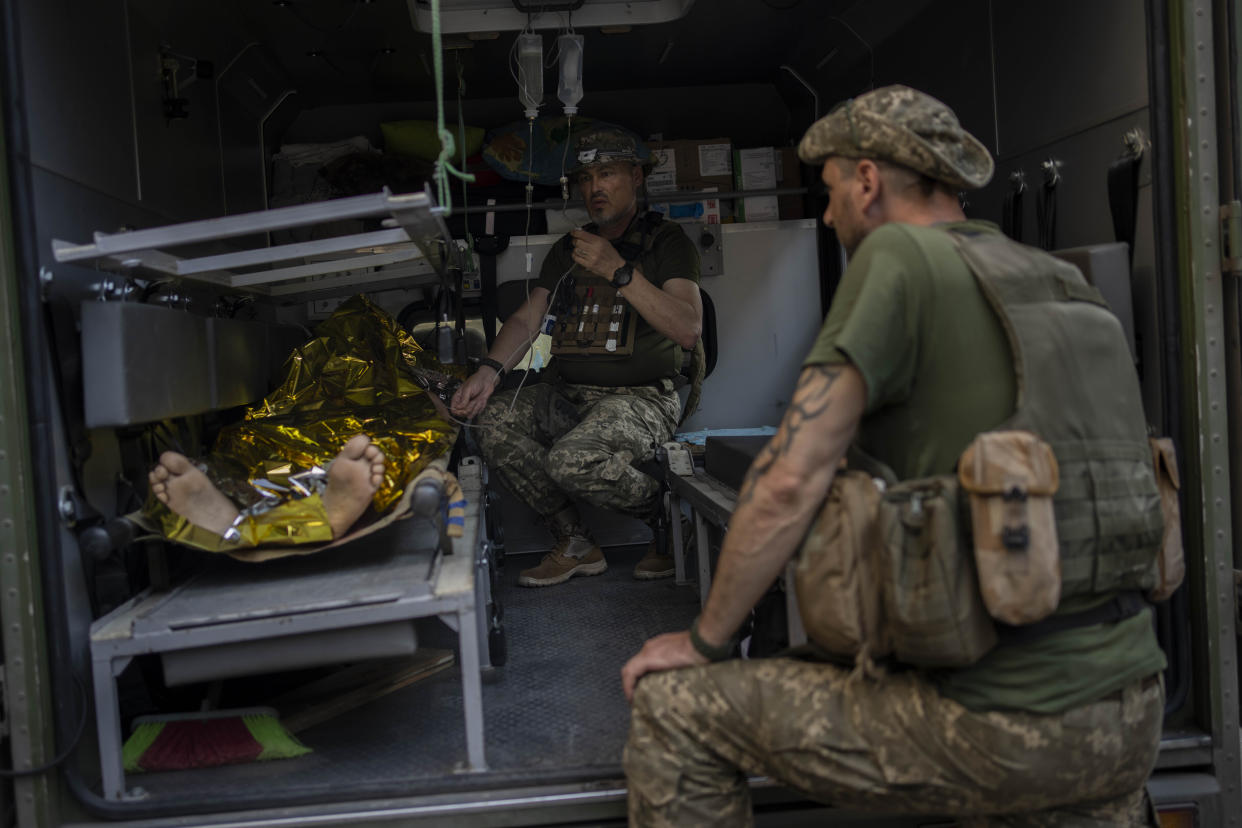 An injured Ukrainian servicemen is transferred to a medical facility after getting an emergency medical treatment in the  Donetsk region, eastern Ukraine, Tuesday, June 7, 2022. (AP Photo/Bernat Armangue)
