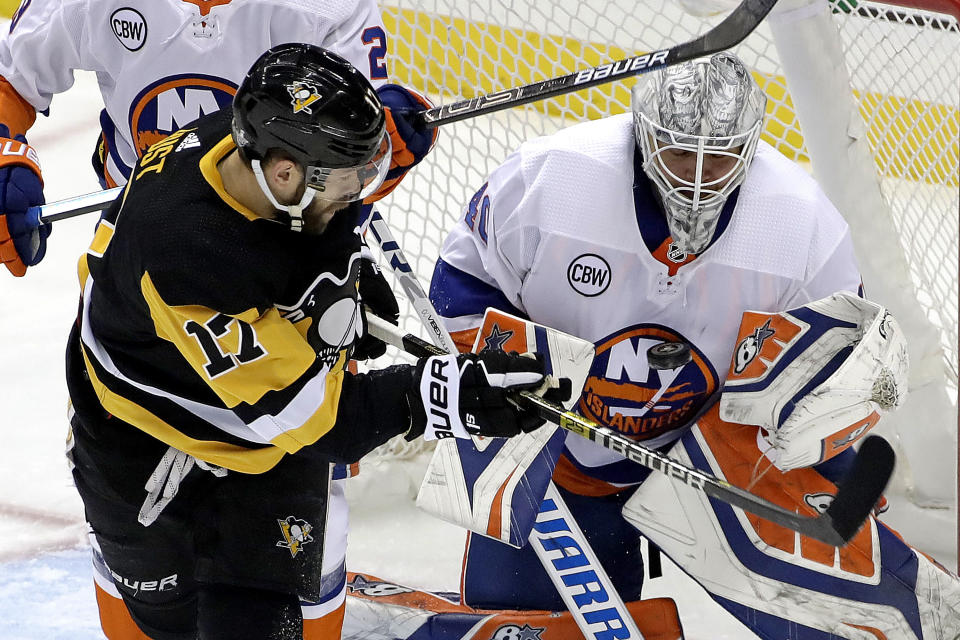 Pittsburgh Penguins' Bryan Rust (17) can't get to a rebound off New York Islanders goaltender Robin Lehner (40) during the first period in Game 4 of an NHL first-round hockey playoff series in Pittsburgh, Tuesday, April 16, 2019. (AP Photo/Gene J. Puskar)