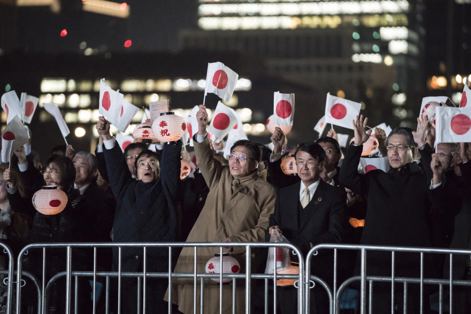 Well-wishers hold Japanese national flags as they cheer during a national festival to celebrate his enthronement at the Imperial Palace in Tokyo Saturday, Nov. 9, 2019. Naruhito thanked tens of thousands of well-wishers who gathered outside the palace to congratulate his enthronement at the ceremony organized by conservative political and business groups. (Tomohiro Ohsumi/Pool Photo via AP)