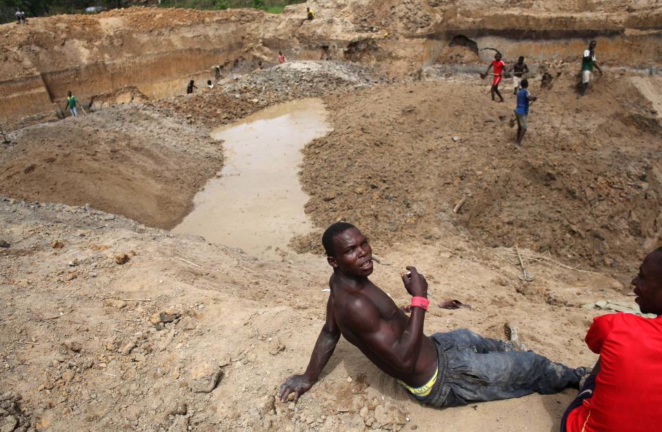 Prospectors take a break as they pan for gold and diamonds near the town of Gaga