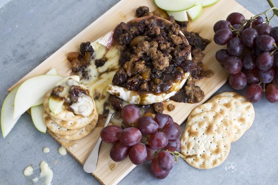 This April 1, 2013 photo taken in Concord, N.H. shows a recipe for cedar-planked pecan, bourbon and brown sugar glazed brie. (AP Photo/Matthew Mead)