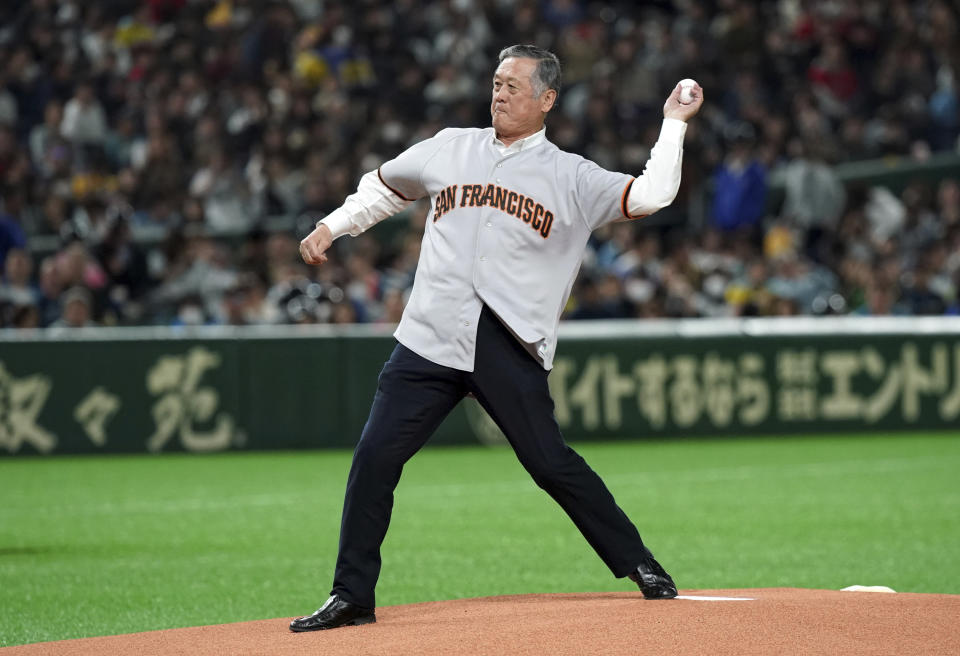 FILE - Former San Francisco Giants pitcher Masanori Murakami, the first Japanese major leaguer, throws the ceremonial first pitch before a pre-season exhibition baseball game between the Oakland Athletics and the Nippon Ham Fighters at Tokyo Dome in Tokyo, Sunday, March 17, 2019. With full respect to Masanori Murakami, who played briefly with the San Fransisco Giants in 1964-65, Japan's odyssey in the Majors began with pitcher Hideki Nomo, the National League Rookie of the Year after joining the Dodgers in 1995. (AP Photo/Eugene Hoshiko, File)