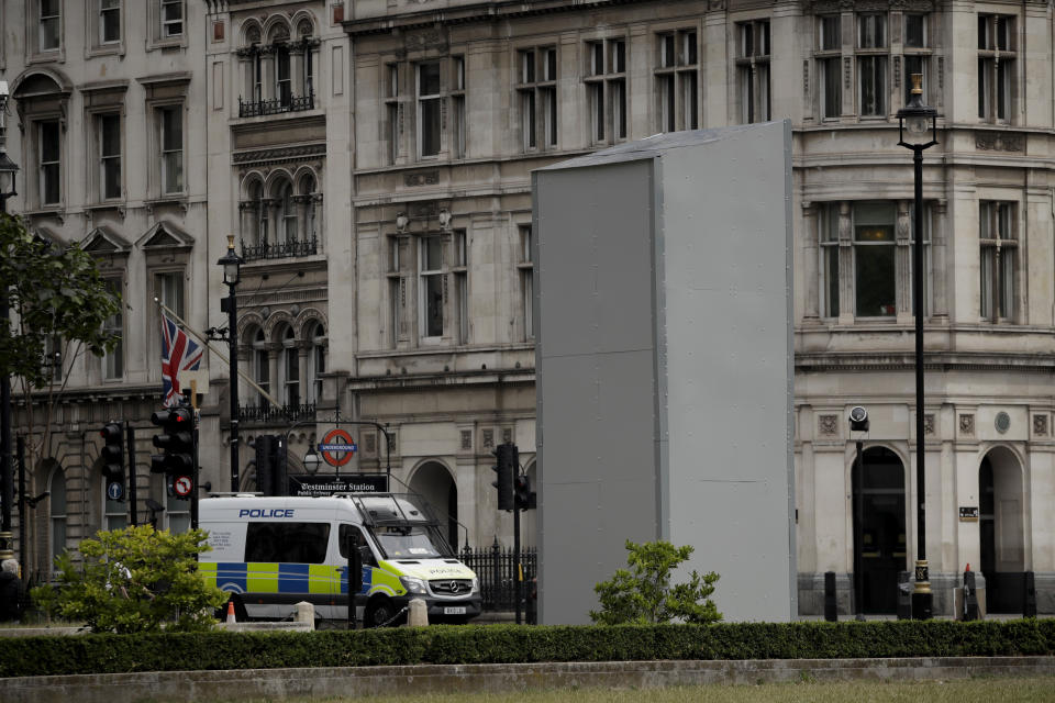 A protective screen put up late Thursday encloses the statue of Britain's World War II Prime Minister Winston Churchill ahead of expected rival demonstrations by anti-racism and far-right protesters in London, Friday, June 12, 2020. Last Sunday the statue was daubed with the words "was a racist" during a protest against racism and police violence after the May 25 death of George Floyd, a black man who died after a white Minneapolis U.S. police officer pressed a knee to his neck. (AP Photo/Matt Dunham)