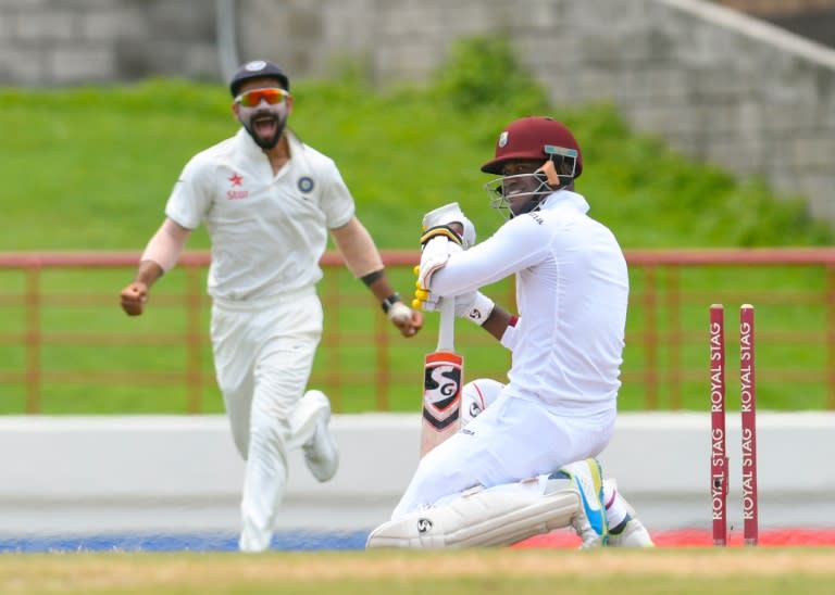 Marlon Samuels (R) of West Indies is bowled by Ishant Sharma of India, as India captain Virat Kohli (L) celebrates during the final day of the third Test