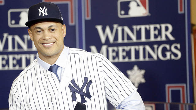 Giancarlo Stanton is happy to leave behind the Miami Marlins to join the New York Yankees. (AP)