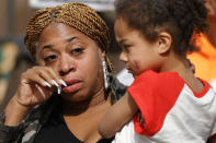 Porchse Miller, left, wipes a tear from her face during a protest, Saturday, Jan. 28, 2023, in Atlanta, over the death of Tyre Nichols, who died after being beaten by Memphis, Tenn., police. (AP Photo/Alex Slitz)