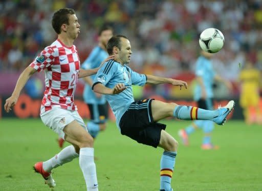 Croatian midfielder Ivan Perisic (L) challenges Spain's Andres Iniesta during their Euro 2012 on June 18. Spain defeated Croatia 1-0 to top the group and leave the Croatians to take an early flight home