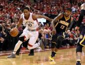 Toronto Raptors guard DeMar DeRozan (10) dribbles away from Indiana Pacers forward Paul George (13) in game seven of the first round of the 2016 NBA Playoffs at Air Canada Centre. Mandatory Credit: Dan Hamilton-USA TODAY Sports